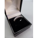 18ct White Gold Half Hoop ET Ring, set with 9 approx: 0.05ct Brilliant cut diamonds. Size approx: ‘