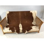 Bergere two seater sofa with genuine Cowhide Throw