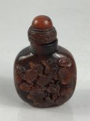 Chinese Cinnabar Snuff bottle depicting fish on either side and with an eight figure character mark