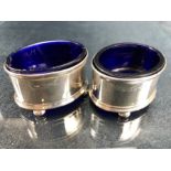 Pair of Hallmarked Silver cruets on silver bun feet with blue glass liners (A/F)