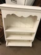 White painted hanging shelving unit