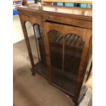Glass display cabinet on ball and claw feet