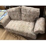 Upholstered sofa with drop arms