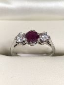 Ruby and Diamond 3 stone ring in 18ct White Gold. Central Ruby measures approx: 5.06mm in diameter