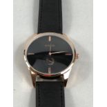 Rose Gold black face watch with suede strap marked RADO