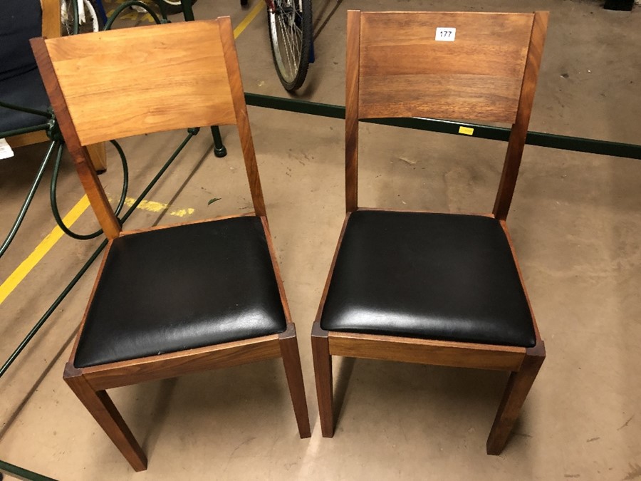 Pair of teak framed dining chairs with Black padded seats