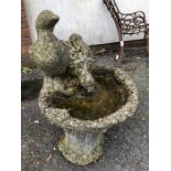 Small weathered garden bird bath with two ducks