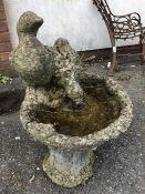 Small weathered garden bird bath with two ducks