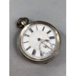 Silver Pocket watch with White face and Roman numerals marked 935 (winds and runs)