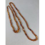 WITHDRAWN: Two sets of Amber coloured beads one with 9ct clasp