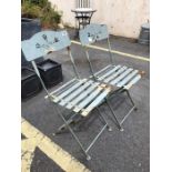 Pair of metal folding garden chairs with pierced backs