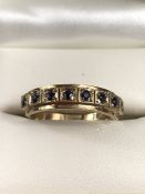 9ct Gold ring set with eight gemstones in square mounts