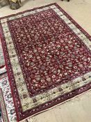 Red ground Kashmir rug with all-over floral pattern and gold border approx. 240cm x 160cm