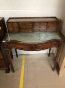 Elegant writing desk with gallery of small drawers and leather top