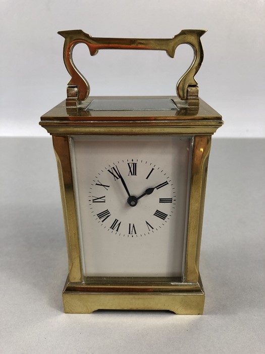 A circa 1900 brass carriage clock, the rectangular face with circular chapter ring set with Roman