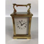 A circa 1900 brass carriage clock, the rectangular face with circular chapter ring set with Roman