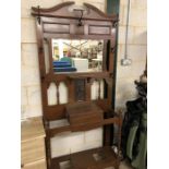 Arts and crafts hall stand with central copper plate and coat hooks