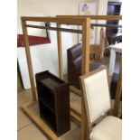 Modern hanging rail in wooden frame on wheels