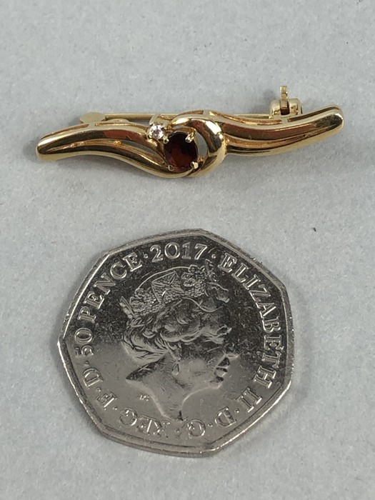 9ct Gold marked 375 Brooch set with central faceted Garnet and a single Diamond - Image 6 of 6