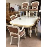 Extending painted dining room table with eight upholstered chairs (two carvers)