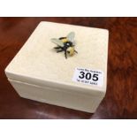 An unusual square ceramic box with honeycomb pattern lid and bee finial