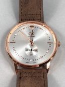 Large faced Rose gold coloured Watch by calvin Klein with brown suede strap