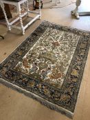 Cream ground rug with floral and bird design approx 200cm x 135cm