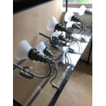 Four pairs of metal wall lights in pale green with glass shades