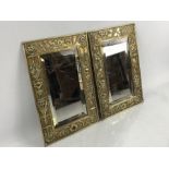 Pair of Victorian brass wall mirrors, one with repousse urn, garland and foliate scroll