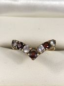 9ct Gold Wishbone Ring, Set with 4 (CZ) stones and 3 Red (Garnet) stones. Size approx: ‘O’ UK, ‘7’