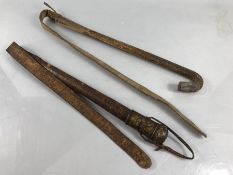 Two leather and wooden camel whips