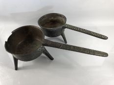 Two heavy cast Bronze skillets one marked "ASBROUGH" (A/F) the other "COX. TAUNTON. V" (A/F)
