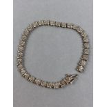 9ct Gold Bracelet with starburst links each set with a Diamond and separated by 9ct gold swoosh.