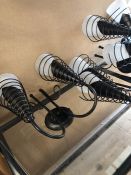 Four pairs of metal wall lights in black with glass shades