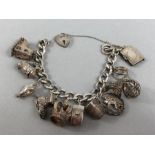 Silver hallmarked bracelet and a selection of silver charms (mostly marked silver) total weight