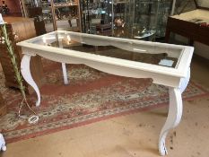 Large white painted french-style bombe-legged display table with glass top. Approx dimensions