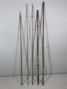 Selection of vintage wooden and cane fishing rods