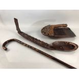 Maori carved items to include walking stick scoops and a boat