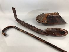 Maori carved items to include walking stick scoops and a boat