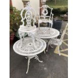 Two decorative wrought iron white painted garden tables and three chairs