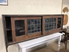 Long vintage wall cupboard with sliding leaded glazed doors approx 203cm x 42cm x 83cm tall