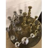 Collection of Glass, Silver plated and Brass candlesticks over two shelves