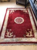 Red ground rug with dragon motif approx 190cm x 135cm