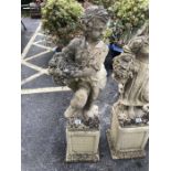 Stonework figure of a boy carrying a basket of fruit approx 110cm tall