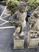 Stonework figure of a boy carrying a basket of fruit approx 110cm tall