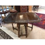 Heavily carved oak drop leaf table with barley twist legs