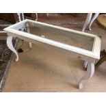 White painted french-style bombe-legged low table with glass top. Approx dimensions 122cm x 50cm x