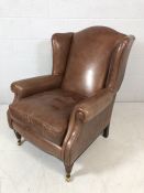 Contemporary brown leather wing-back armchair