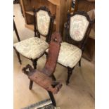 Pair of upholstered chairs with carved detailing and a carved stool