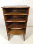 Four tier stained wooden bookcase with curved-fronted shelves. Height approx 107cm, width approx